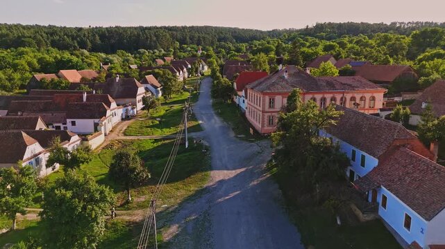 Aerial view of a stork nest in Viscri village, Romania. Viscri Village, famous travel destination in Romania. Authentic village with old houses. Single stork in the nest at sunset. Beautiful landscape