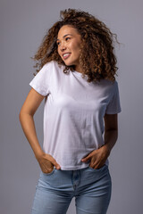 Young Woman In Plain White T-Shirt And Jeans Posing On Gray Background