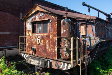 Rusty industrial locomotive at abandoned and dilapidated remnants like blast furnaces of the old steel manufacturing plant in Bethlehem, Pennsylvania, USA
