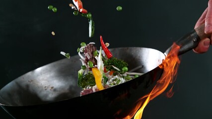Super slow motion of flying asian wok ingredients . Filmed on high speed cinema camera, 1000 fps - Powered by Adobe