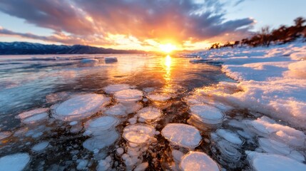 A stunning winter sunset over a frozen lake, featuring unique ice bubbles floating on the surface, highlighting nature's beauty and the magic of seasonal transformations.