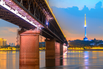 Yangtze River Bridge and skyscrapers along the river, night view of Wuhan, China.