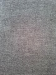 Fototapeta premium Fabric texture close-up – Detailed view of a grey textile surface with visible fibers and woven pattern