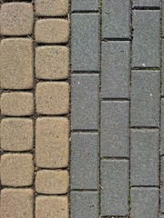 Two types of paving stones — square and rectangular — side by side. Urban ground texture for architecture and infrastructure projects.