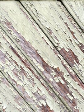 Vintage painted wood background texture with diagonal boards and peeling white paint