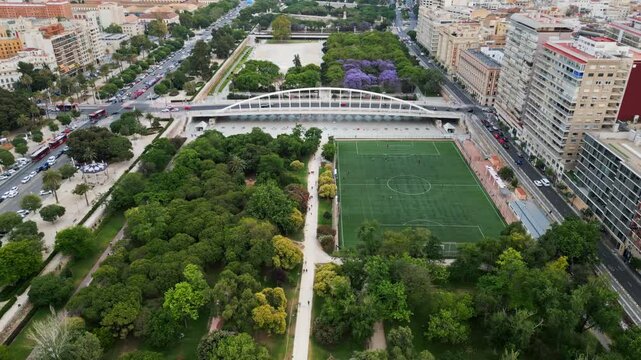 Cars and public transportation moving on the Exhibition Bridge near the Mestalla Stadium, and the Turia Gardens Park in Valencia, Spain