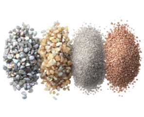 Four piles of various colored small stones or sand