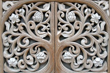 Intricate wood carving, symmetrical design of stylized tree and floral motifs