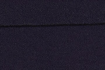 Close-up view of dark navy blue fabric with a seam