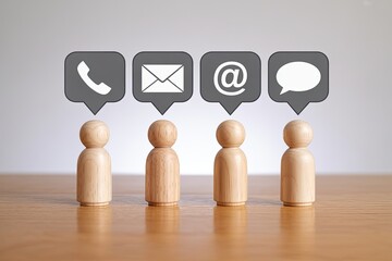 Four wooden peg people standing in a row each with a different communication icon above their heads representing contact methods