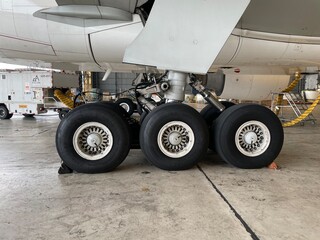 Close-Up of Large Aircraft Landing Gear in a Maintenance Hangar.

