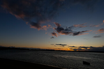 Bright white clouds drifting across deep blue sky