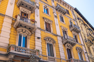 Yellow bright old house with balcony in La Spezia city. Shutters on the windows. Italy architecture.