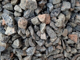 close up of crushed rock, stone raw material for construction industry. background and texture.  