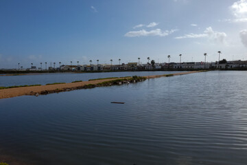 Salt marshes reflecting the blue sky near the city of faro in portugal