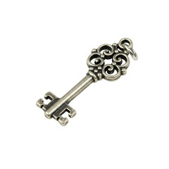 Small, exquisite, aged silver antique-style ornate metal key charm with intricate filigree, standalone, against a pristine transparent isolated background, concept of high-end product photography