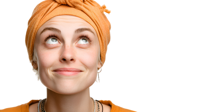 Portrait of a Young Woman Wearing an Orange Turban Looking Upward Thoughtfully Against a Neutral Background. Her Expression is Curious and