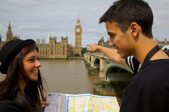 Big Ben and young couple looking at map, London, England