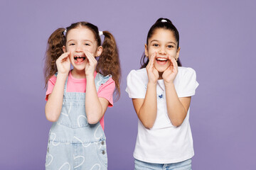 Little two friends kids children girls 9-10 year old wear casual clothes together scream sharing hot news about sales discount hands near mouth isolated on plain purple background. Lifestyle concept.