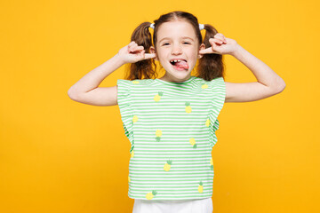 Little toothy kid child girl 8-9 years old wear green t-shirt show make stick tongue out sign,...