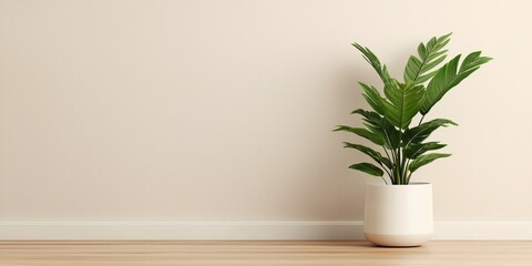 A vibrant green plant in a minimalist white pot, set against a soft beige wall, adding a touch of nature to a modern indoor space.
