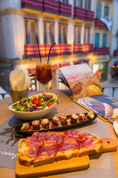 View of traditional Spanish tapas overlooking Plaza del Siglo at dusk, Malaga, Costa del Sol, Andalusia, Spain