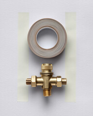Brass valve and tape on technical background