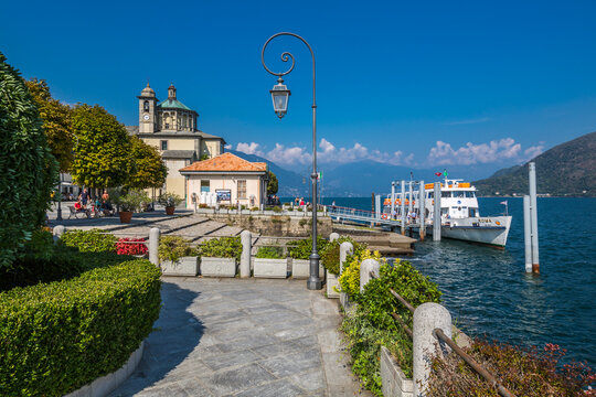 Cruiseboat moored near harbour and Santuario della SS Pieta Church in Cannobio, Lake Maggiore, Piedmont, Italian Lakes, Italy