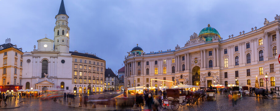 Christmas Market stalls and St. Michael Catholic Church in Michaelerplatz, Vienna, Austria