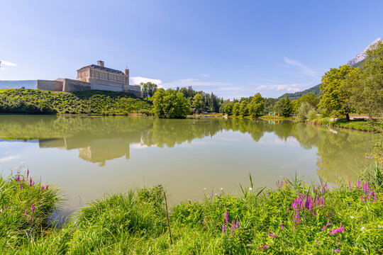 View of Trautenfels Castle reflection in Schlossteich Fischstoberl fishing pond, Styria, Austria