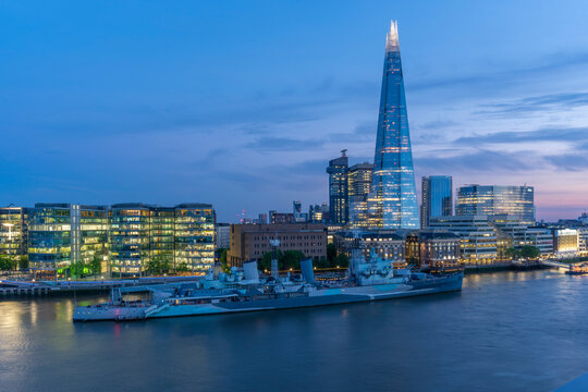 View of the Shard, HMS Belfast and River Thames from Cheval Three Quays at dusk, London, England