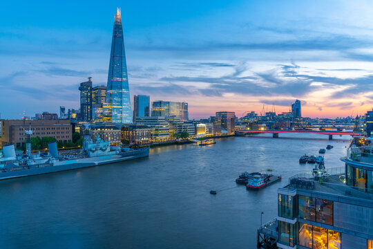 View of The Shard, HMS Belfast and River Thames from Cheval Three Quays at dusk, London, England