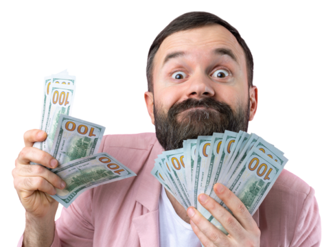 Portrait of a contented young businessman with a beard dressed in a pink jacket showing us dollar banknotes against a red studio background. Taste, smell of money.