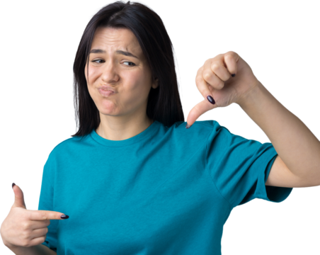 Young brunette in a blue tank top giving thumb down gesture looking with negative expression