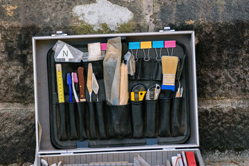 A professional case with tools for careful excavation work.