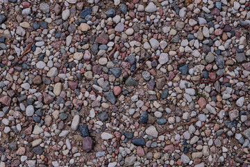 Textured ground covered in small colorful stones and pebbles at a natural outdoor location