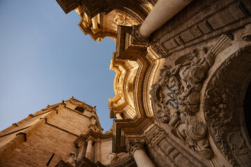 Valencia Cathedral external arched entrance with bell tower in Valencia, Spain