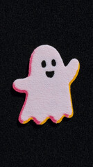 The image features a cartoonish pink ghost with a cheerful expression, outlined in yellow. It has a textured surface and is set against a solid black background.