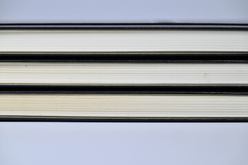 Fototapeta premium Stacked hardcover book page edge texture background