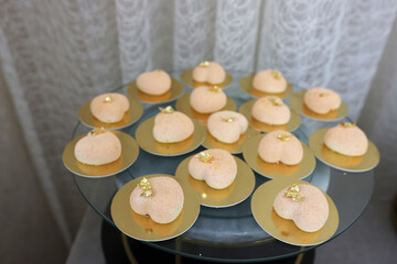 A tray of cakes and pastries on a buffet table.