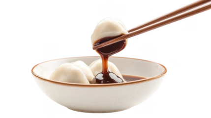 Steaming dumplings are lifted from a bowl, dripping with thick soy sauce in a stylish dining atmosphere