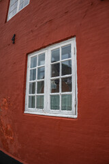 Fanø summer 2024, Denmark - Old deep red house with white window