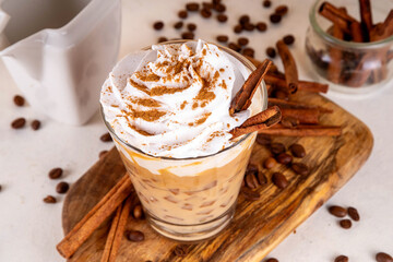 Iced cinnamon latte with whipped cream
