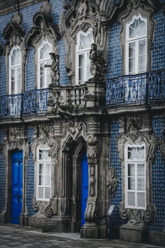 Porto, Portugal - 17 June 2022: View of the detailed facade of the Pal&Atilde;&iexcl;cio da Bolsa, its blue tiles and ornate windows creating a striking contrast against the stone carvings.