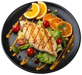 grilled chicken on a black plate with orange sauce