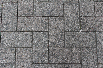 Brown and gray paving tile. Brick pavement texture. Interlocking concrete pavers close up background.