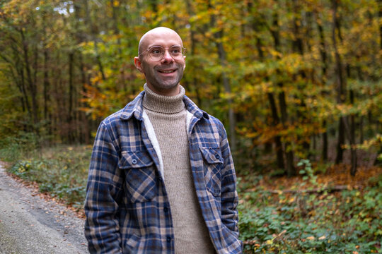 happy positive caucasian young man 30-35 years old smiling on green natural background, good mood, age-related changes, mental human health