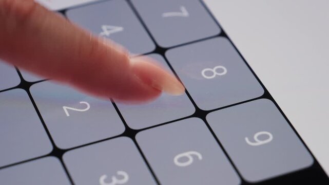 Footage of a person doing basic math on a smartphone calculator. High quality 4k footage