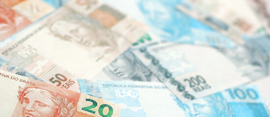 Brazilian reais banknotes. The current Brazil real money bills lies on table in big amount