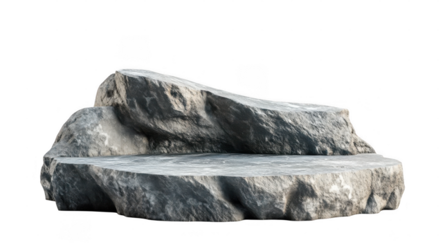 A large rock formation displays rough textures and a flat surface, resting under natural light in an outdoor setting